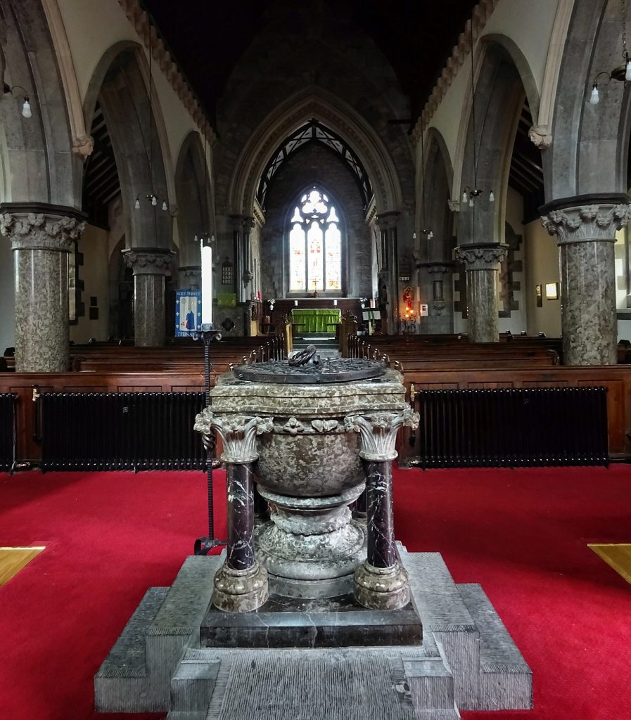 Looking from marble font towards the East window of Holy Trinity Trefnant. Marble columns down each side.